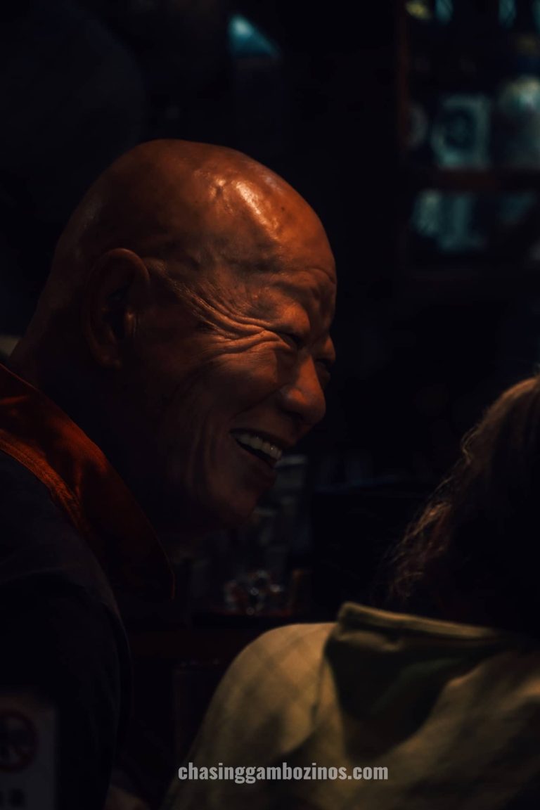 Japanese old man smiling in shinjuku omoide yokocho.