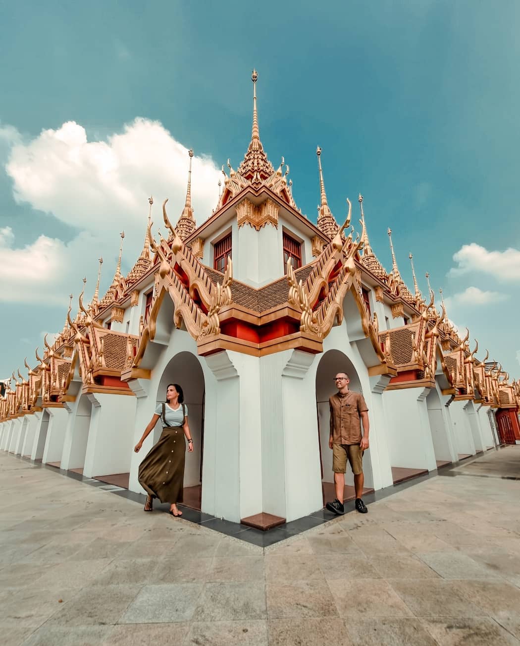 Couple in one of Bangkok best temples to visit, Wat Ratchanatdaram Worawihan, also known as Loha Prasat.
