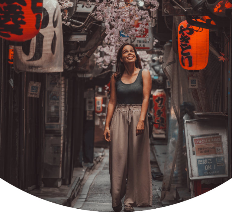 Cover of travel blog on best things to do in Tokyo, featuring a woman walking in Omoide Yokocho, one of the best things to do in Tokyo, Japan.