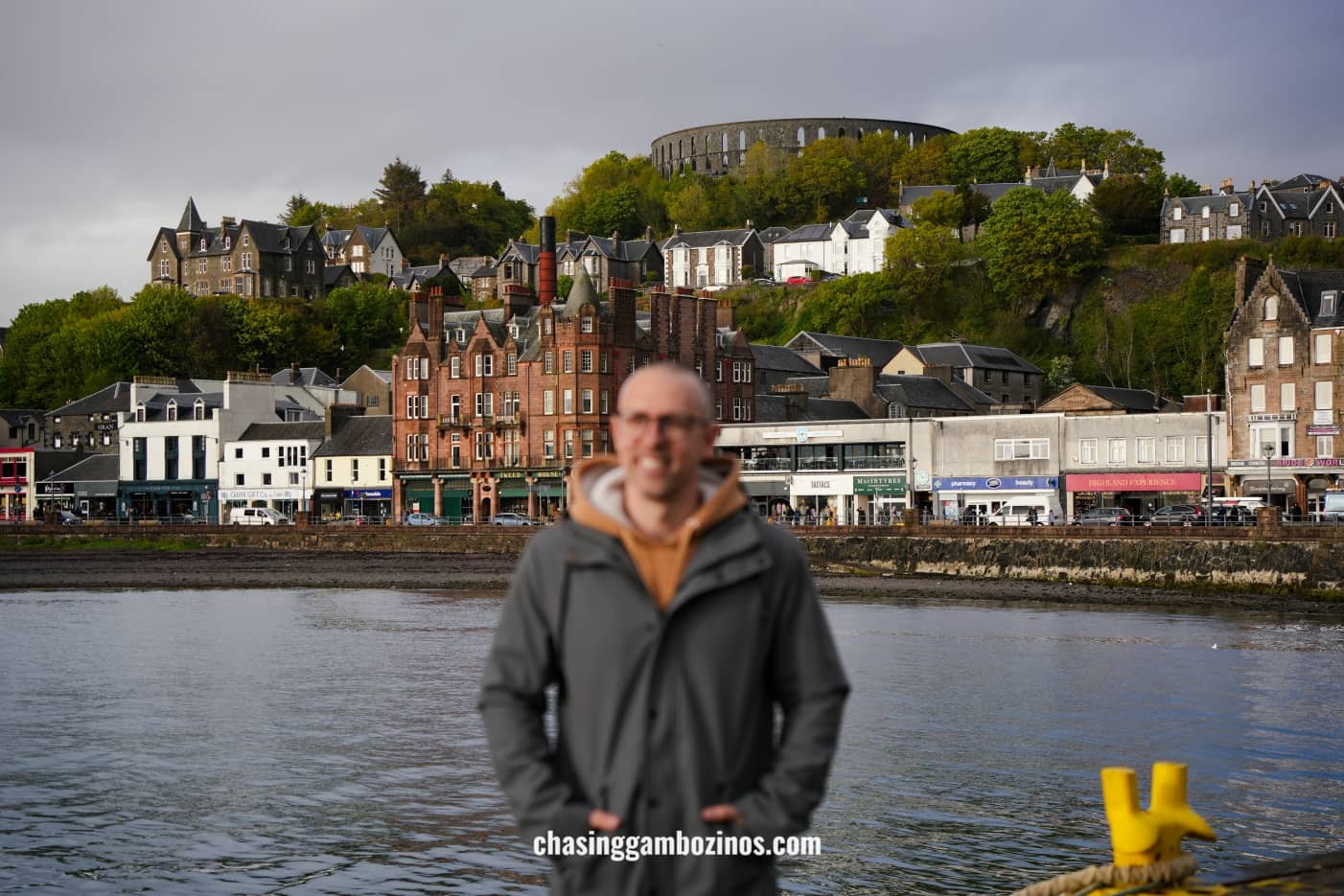 Man smiling with the city of Oban in the background.