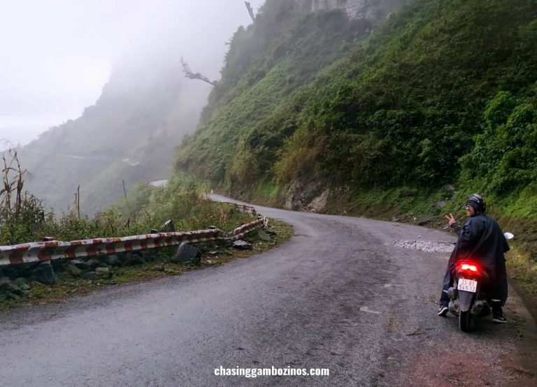 Man doing the Ha Giang loop solo, smiling in a pit stop on the main road.