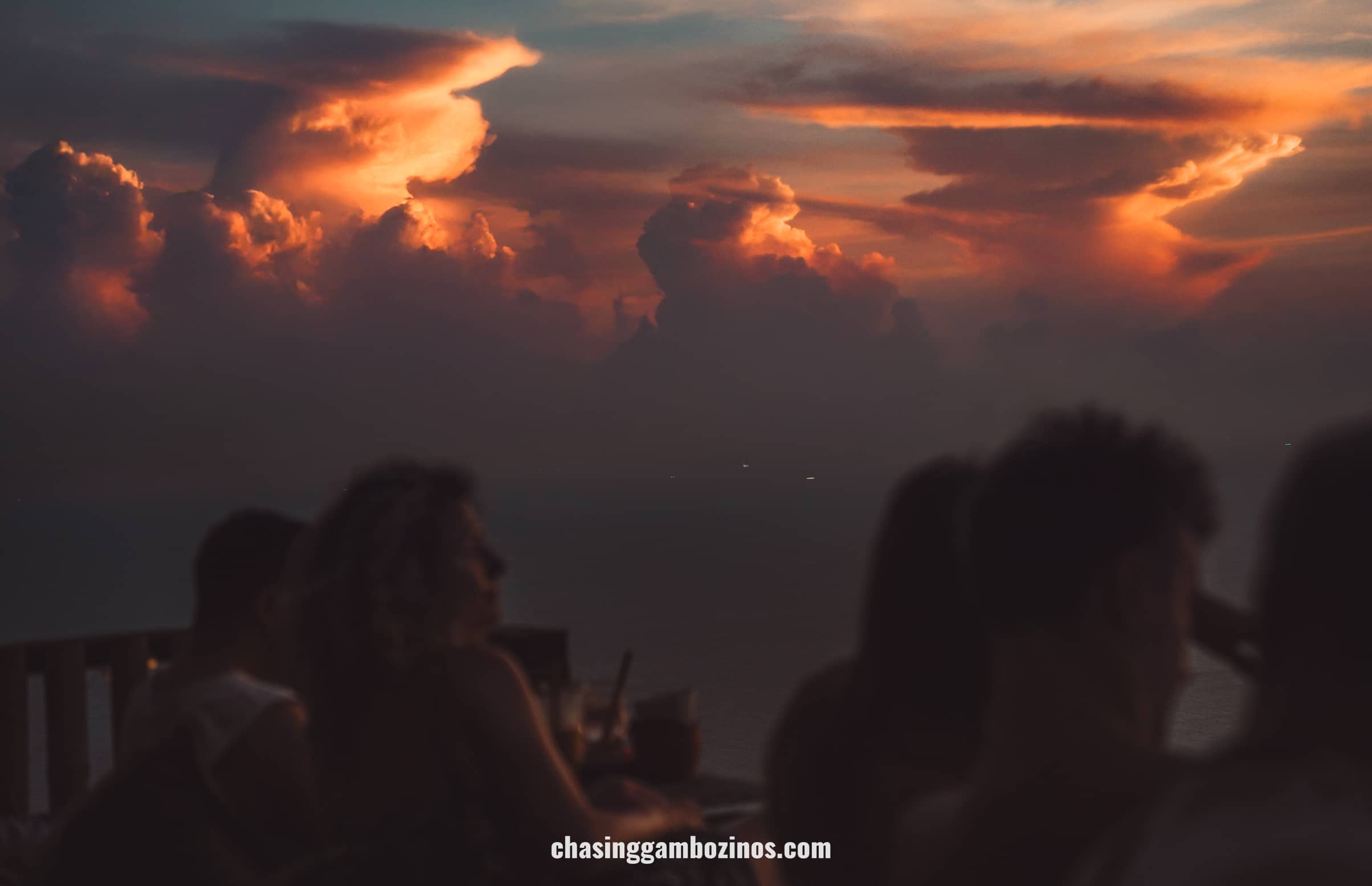 Bar at sunset with sky in red and pink tones and fluffy clouds, on one of the best Kog Tao viewpoints.