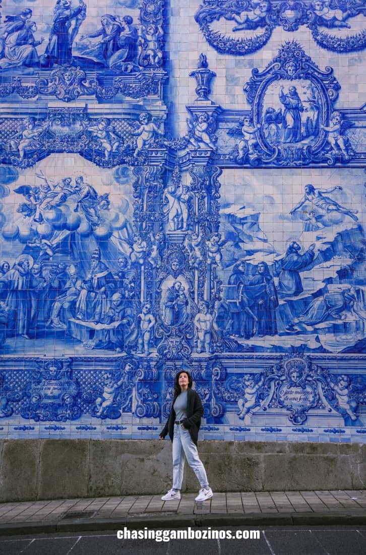 woman in front of instagrammable tiles wall at capela das almas in Porto.